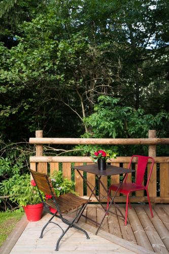 a table and two chairs on a wooden deck at Chalet sur les monts Morzine in Montriond