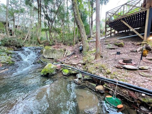 a stream of water next to a house at るり渓 フレアキャビン in Nantan city