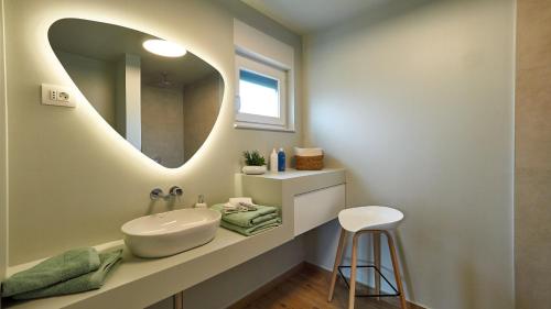 a bathroom with a sink and a mirror at Villa Green Forest with wellness and heated salty pool in Hum