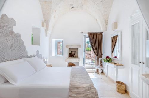 מיטה או מיטות בחדר ב-Masseria Torre Rossa