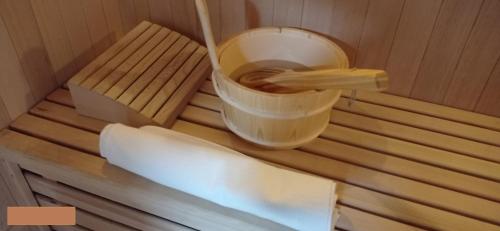 a inside of a sauna with a bucket of water at Robitel Wellness Vendégház Veszprém-Gyulafirátót in Veszprém