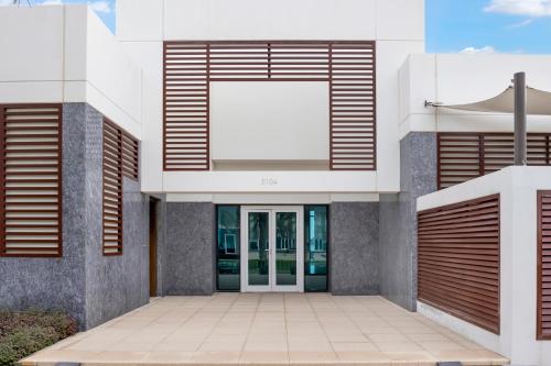 a facade of a building with a white door at FAM Living - Sarai Beachfront Villas - 2 in Dubai