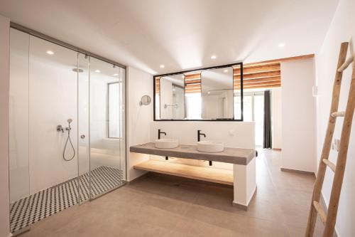 a bathroom with two sinks and a mirror at Ikies of Mykonos in Mýkonos City