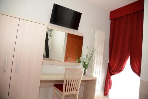 a room with a desk and a tv on a wall at B&B Europa in Potenza