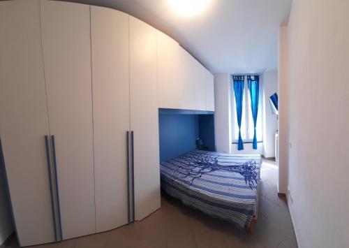 a bedroom with a bed and a white cabinet at ROMANTIC APARTMENT NEAR THE SEA with PRIVATE GARAGE ctr zero undici zero diciassette cav 038 in Levanto