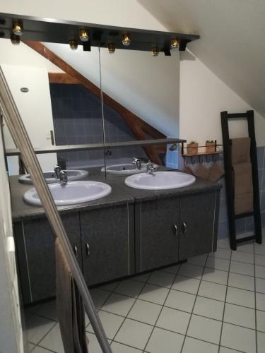 une salle de bain avec deux lavabos et un miroir dans l'établissement la longere de Lor'Phée, à Chantepie