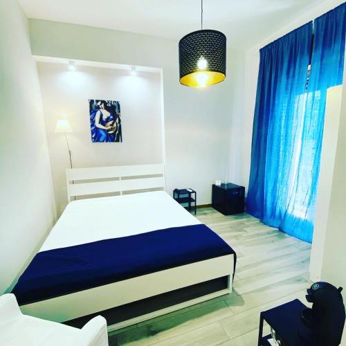 a bedroom with a bed with blue drapes at Le Camere di Rosanna in Marina di Gioiosa Ionica
