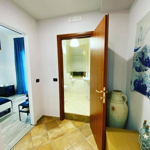 a bathroom with a shower and a glass door at Le Camere di Rosanna in Marina di Gioiosa Ionica