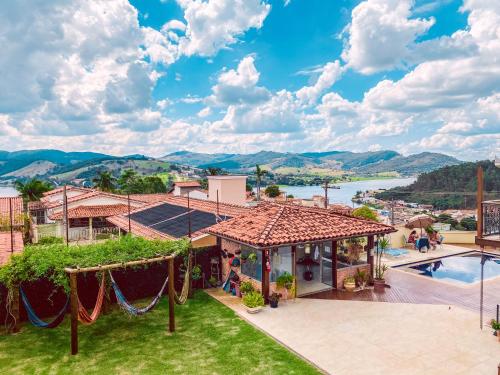 a villa with a view of the water at Pousada Quintal da Lua in Capitólio