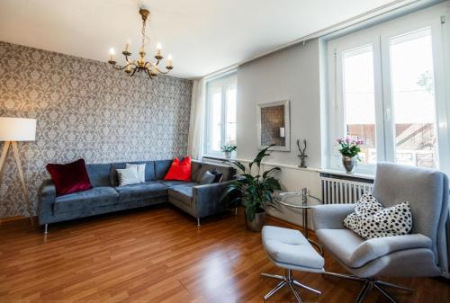 a living room with a couch and two chairs at Hotel & Restaurant Tanne in Fischingen