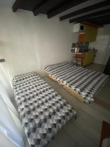 a room with two beds in the corner of a room at House&House 84 in Petropavlovskaya Borshchagovka