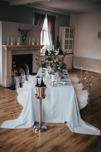 a long white table with chairs and flowers on it at Hotel & Restaurant Tanne in Fischingen