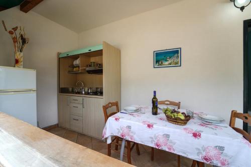 a kitchen with a table with a bottle of wine at casa vacanze margherita in Capo Vaticano