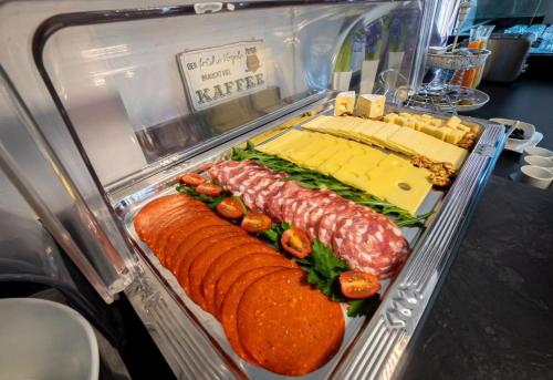 a display case with sandwiches and meats and cheese at Hotel & Restaurant Tanne in Fischingen