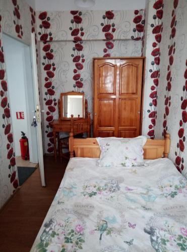 a bedroom with a bed and a dresser and a mirror at Casablanca City in Varna City