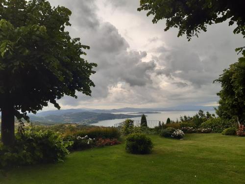 a view of a lawn with a view of a lake at Villa La Moraiola in Passignano sul Trasimeno