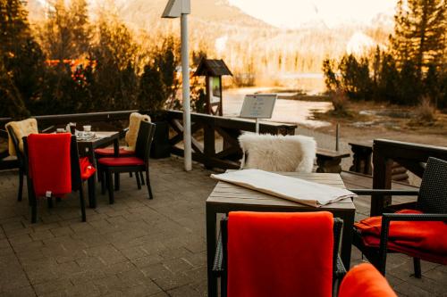a restaurant with tables and chairs with a view of a mountain at Hotel Solisko in Štrbské Pleso