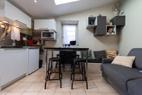 een keuken en een woonkamer met een tafel en stoelen bij Petit gite du Bistrot d ici in Saint-Saturnin