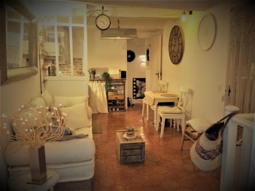 a living room with a white couch and a table at CHARME RAMATUELLE in Ramatuelle