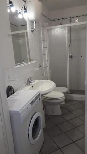 a bathroom with a toilet sink and a washing machine at In Vacanza a Gaeta - MariStella in Gaeta
