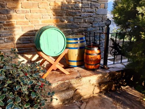 a barrel and two barrels sitting next to a wall at Eth Caneba in Mont