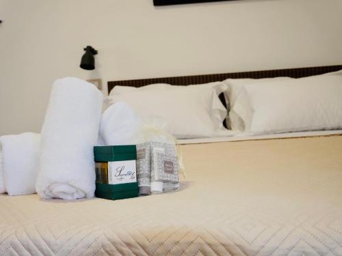a pile of towels and toilet paper on a bed at "Sweet Life" Casa Vacanze in Lipari