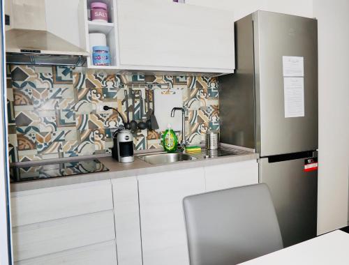 a small kitchen with a sink and a refrigerator at "Sweet Life" Casa Vacanze in Lipari