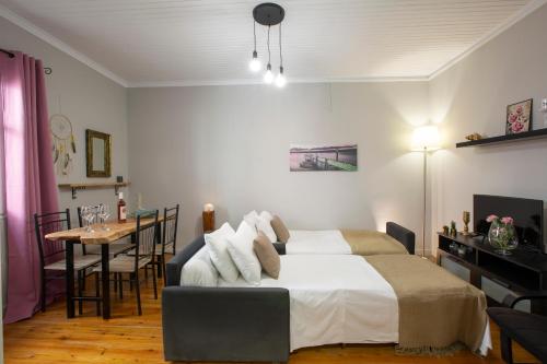 a bedroom with a bed and a table and a dining room at Akratos wine house in Nydri