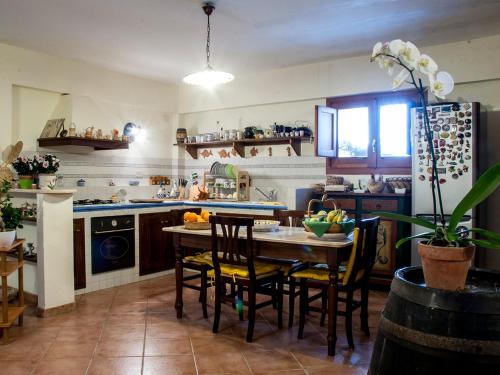 a kitchen with a table and chairs in a room at Bed And Breakfast Maria in Scopello