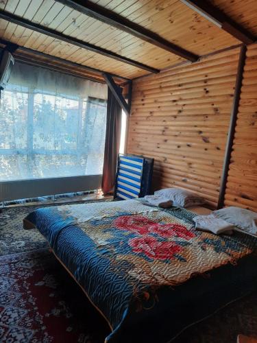 a bedroom with a bed in a room with a window at Kitech Guest House in Odesa