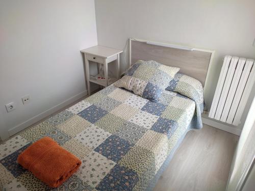 a bedroom with a bed with a quilt on it at Apartseu in La Seu d'Urgell