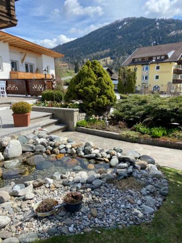 a rock garden in front of a house at Frühstückspension Alpenrose Bed & Breakfast in Iselsberg