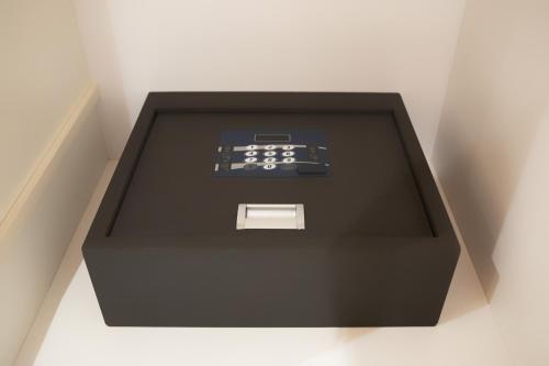 a black box with a remote control in it at 1881 LUXURY SUITES in Verona