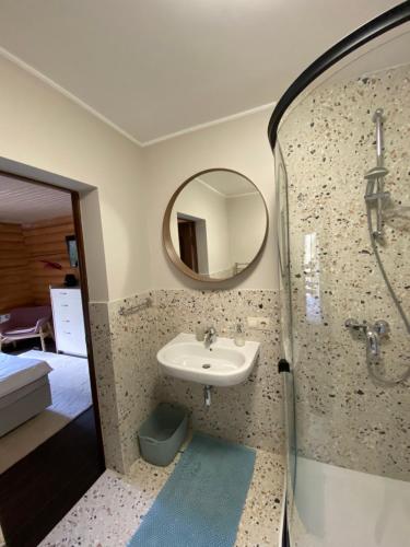 a bathroom with a sink and a mirror at Chalet MelodiyaGir in Pilipets