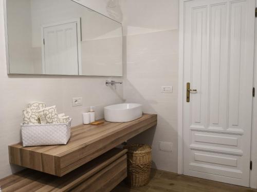 a white bathroom with a sink and a mirror at Villa Maria in Dorgali