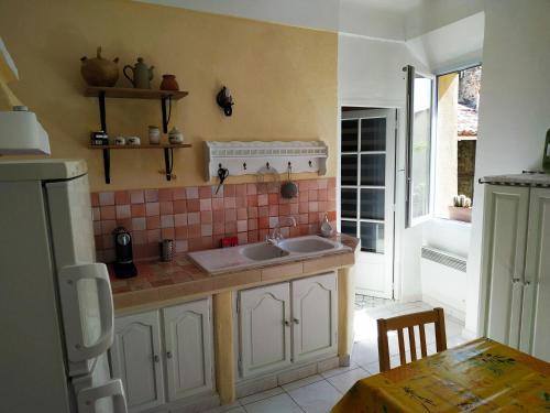 a kitchen with a sink and a counter top at GITE AU COEUR DES GORGES DU VERDON in Quinson