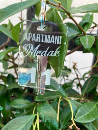 a glass ornament hanging from a plant at Apartments Mrdak in Bar