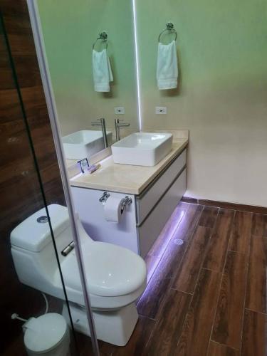 a bathroom with a white toilet and a sink at Mountain View Anapoima in Anapoima