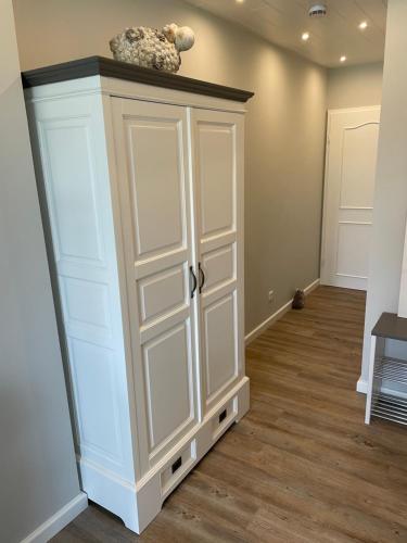 a white cabinet in a room with a hallway at Strandnest in Wyk auf Föhr