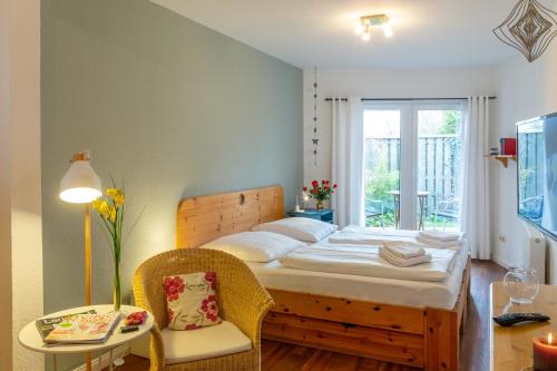 a bedroom with a bed and a table at Haus am Meer in Scharbeutz
