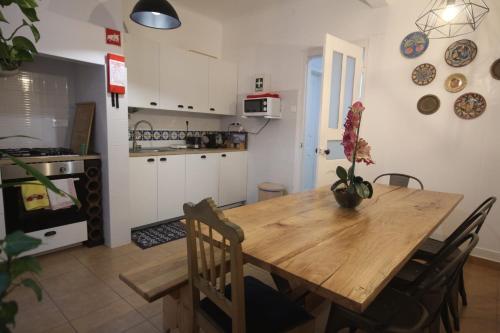 a kitchen and dining room with a wooden table at Nautic M1 R2 - Classy & Cozy Double Room with Shared Bathroom in Marques Pombal in Lisbon