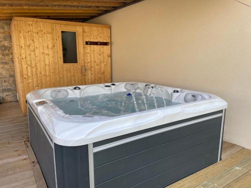 a hot tub in the corner of a room at Casa la Rosa & Spa in Courdimanche-sur-Essonne