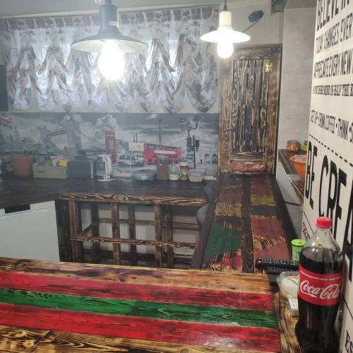 a coke bottle sitting on a table in a room at Like Home Hostel & TOURS in Tiraspol