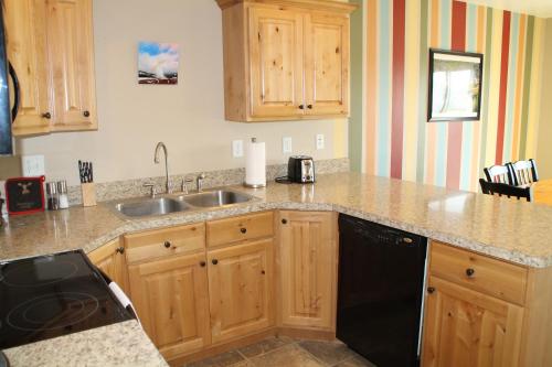 a kitchen with a sink and a dishwasher at 3 queen beds, 1 twin bed, 2 rooms, 1 and a half bath, self check-in, flexcation equipped in Idaho Falls