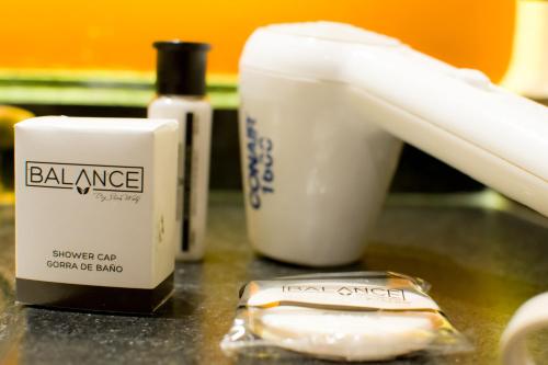 a counter with a bottle of balancer and a toothbrush at Hotel Catalina in Mexico City