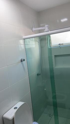 a glass shower in a bathroom with a toilet at Apto lateral mar in Porto Belo