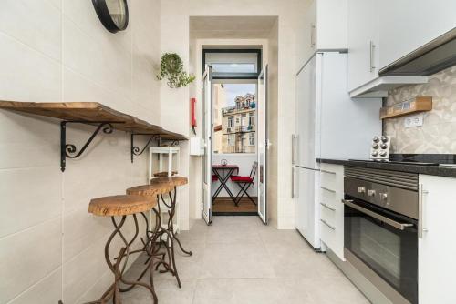 a kitchen with a counter and stools in it at Exotic M2 R2 - Comfortable Classy Double Room with Shared Bath in Lisbon