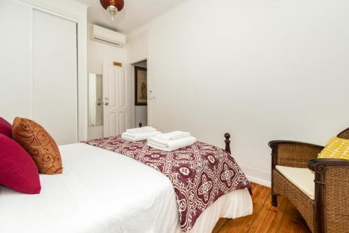 a bedroom with a white bed with towels on it at Exotic M2 R2 - Comfortable Classy Double Room with Shared Bath in Lisbon