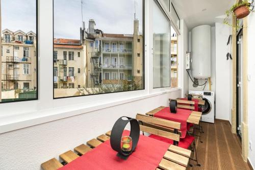 a room with two benches and two windows at Exotic M2 R2 - Comfortable Classy Double Room with Shared Bath in Lisbon