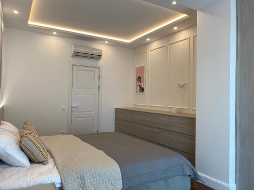 a bedroom with a bed and white cabinets at Modern Classic 2 bedroom apartment near Most City in Dnipro